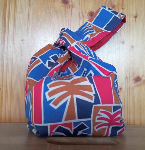 Knitting project knot bag made with a monkey/tree design, uneven handles, inside bordeaux. Size 22*26 cm